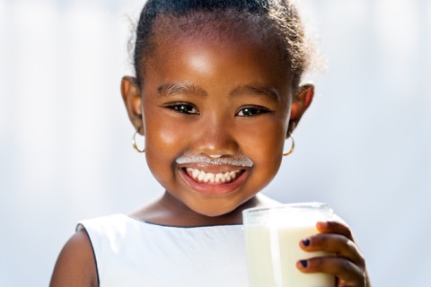 young girl drinking milk