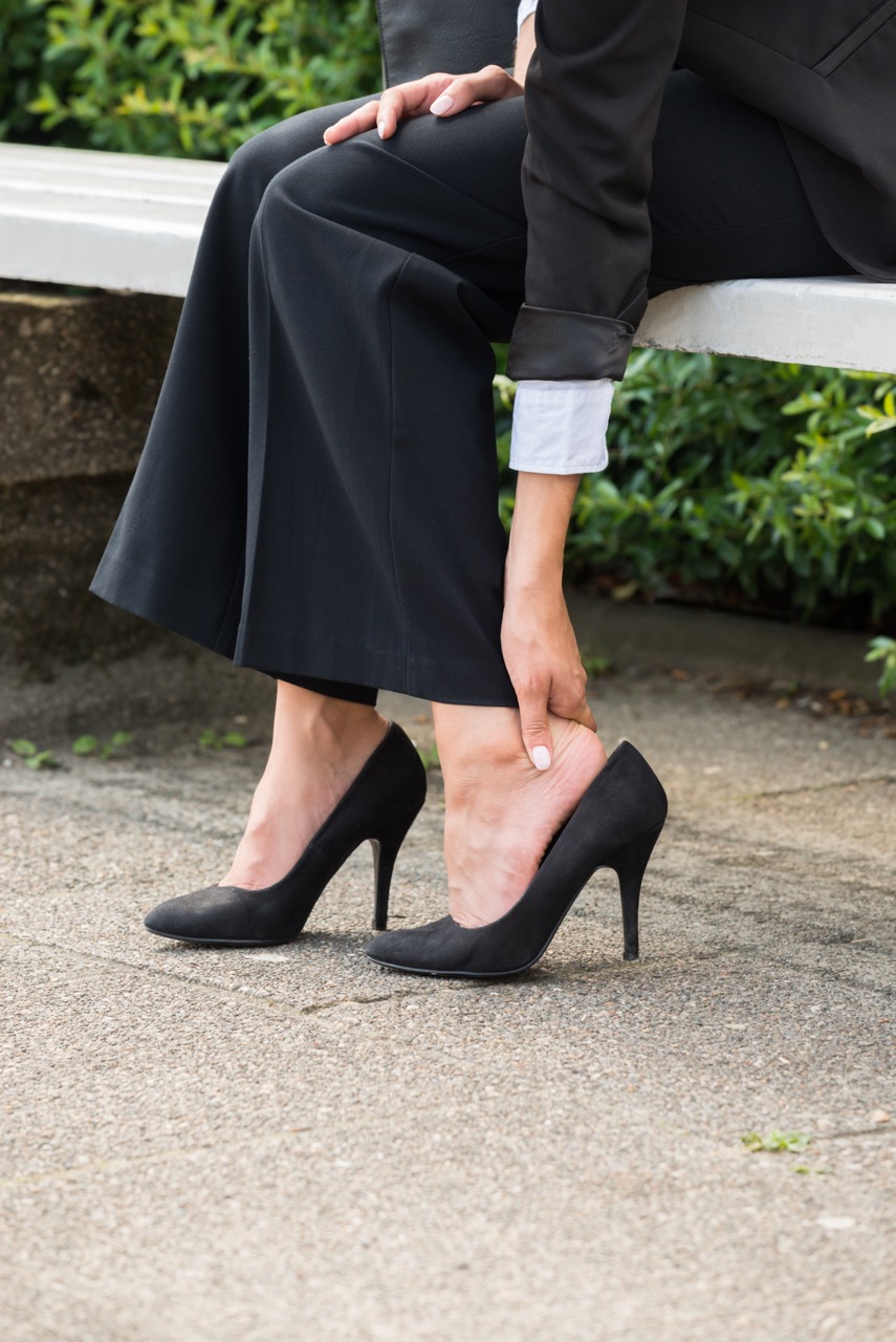 women in black high heels with a bunion
