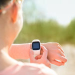 Woman setting wrist fitness tracker for run