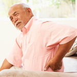 Man with hand on back in pain