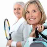 Two mature women playing tennis