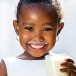 young girl drinking milk
